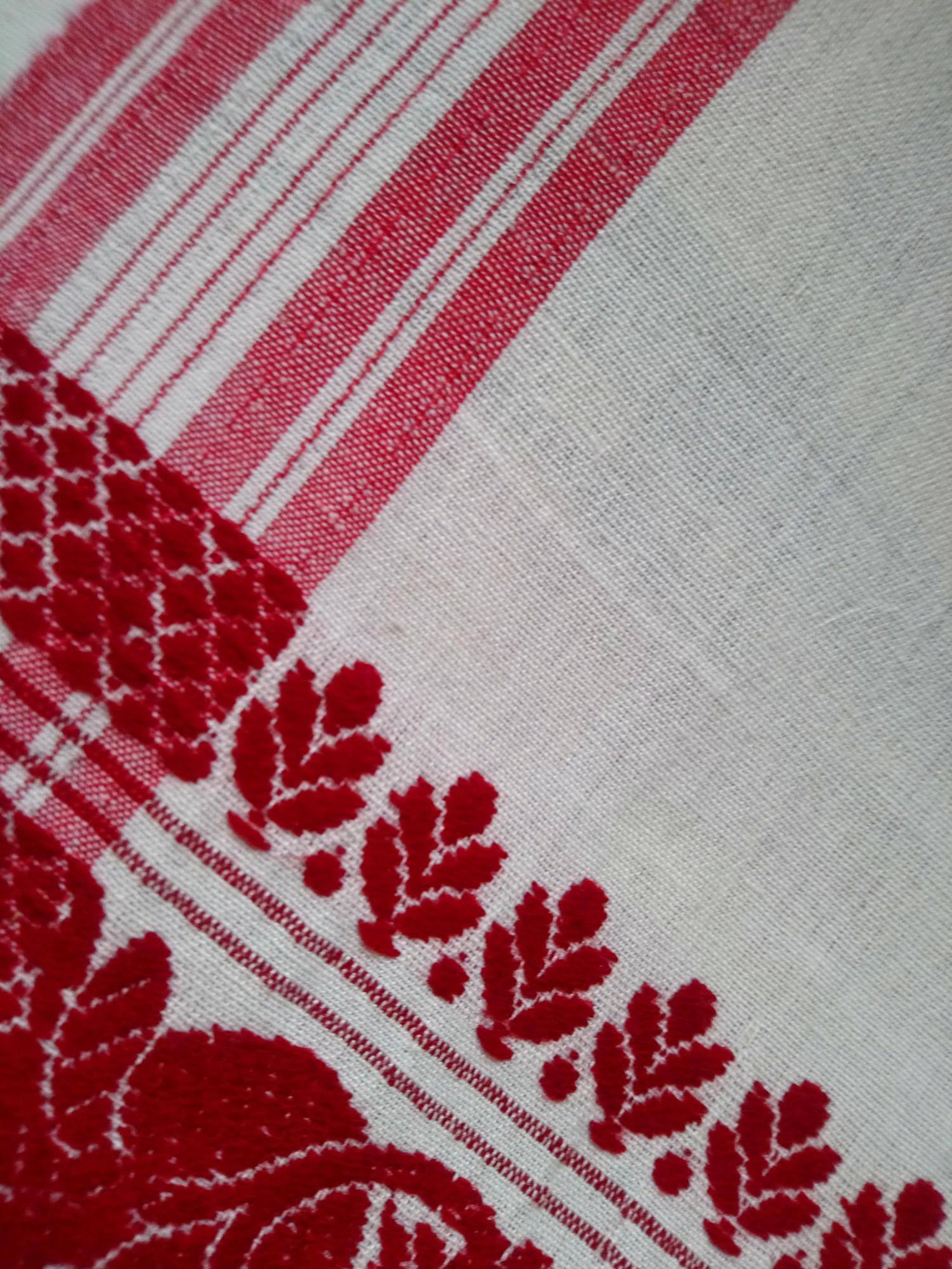 Close detail of red geometric embroidery